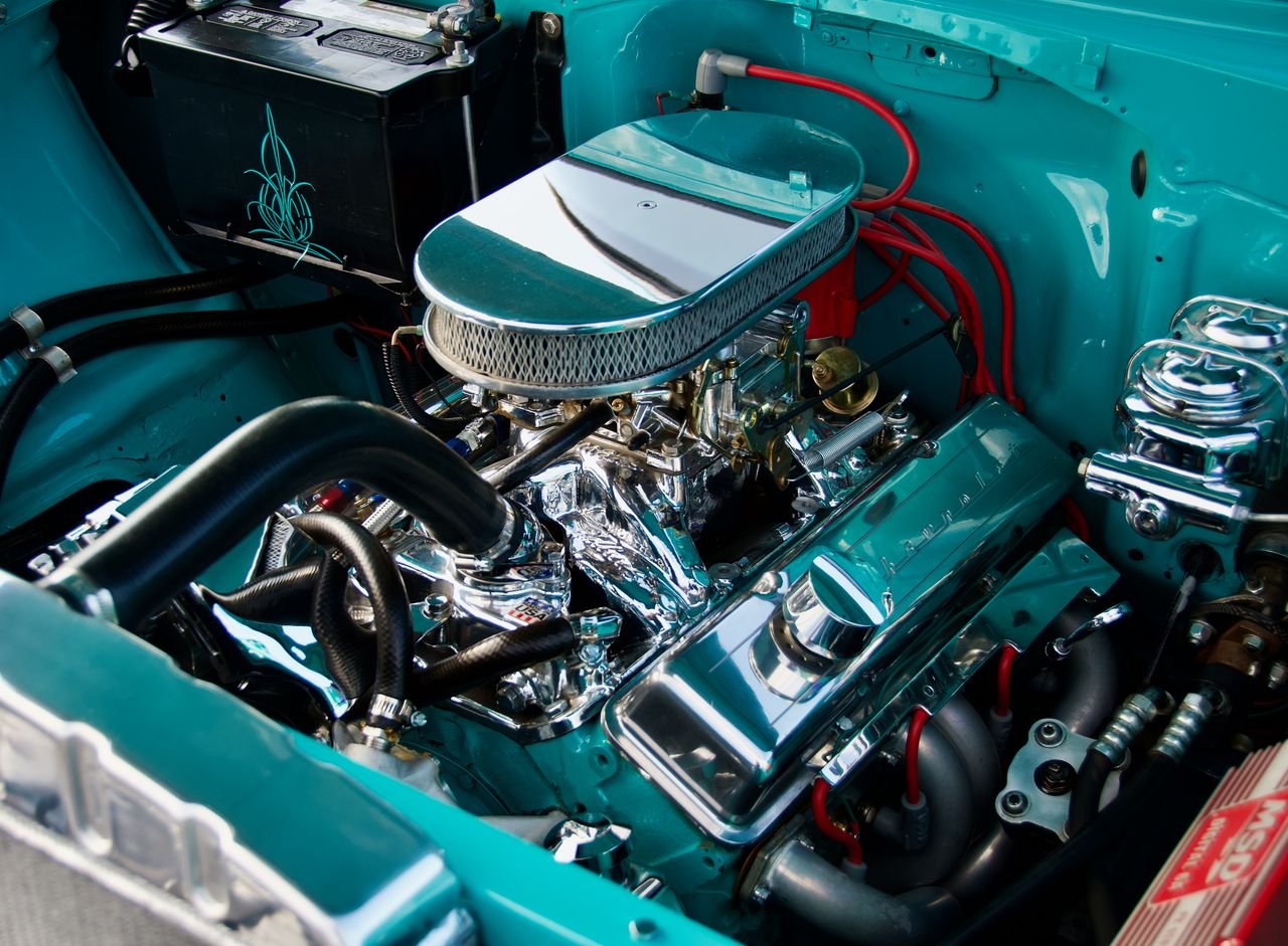 Close-up of a classic car engine with chrome details in a vintage vehicle. High performance and restoration concept.